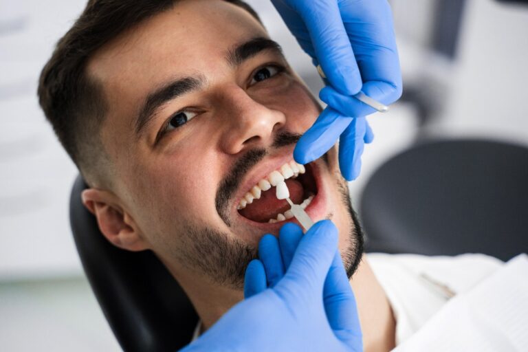 Un homme qui ne supporte pas son bridge dentaire et effectue un soin chez un dentiste